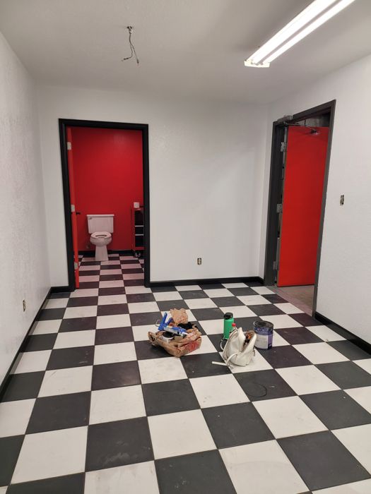 Black and white checkerboard tile floor with black baseboards