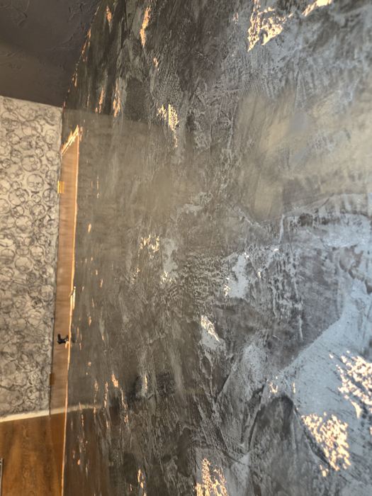 Finished charcoal Venetian plaster wall with copper leaf accents
